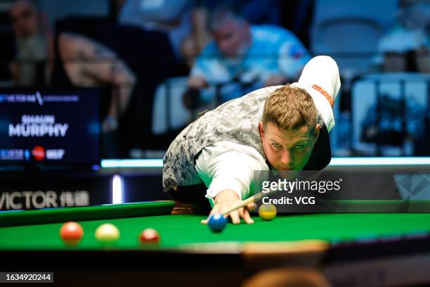 Daniel Wells of Wales plays a shot in the second round match against Shaun Murphy of England on day 2 of Snooker European Masters 2023 at Kia...
