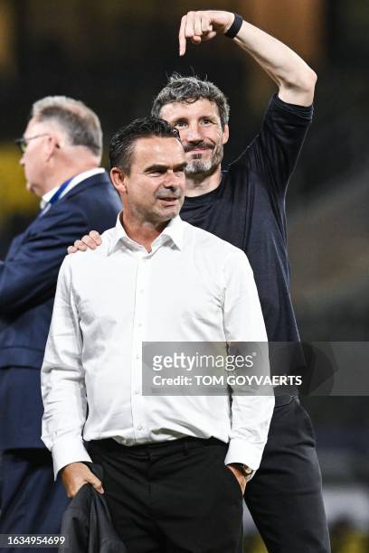 Antwerp's director of football Marc Overmars and Antwerp's head coach Mark van Bommel celebrate after winning a soccer game between Greek AEK Athens...