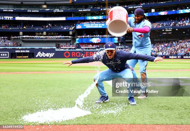 Ernie Clement of the Toronto Blue Jays is doused with water by Vladimir Guerrero Jr. #27 after the win against the Washington Nationals at Rogers...