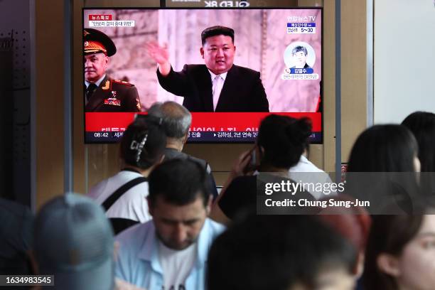 People watch a television broadcast showing a file image of North Korean leader Kim Jong-Un at the Seoul Railway Station on August 24, 2023 in Seoul,...