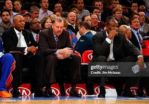 New York Knicks assistant coaches Darrell Walker, Jim Todd and Herb Williams look on during a game against the Detroit Pistons at Madison Square...