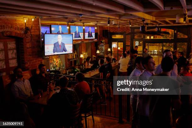 People attend a watch party for the first 2024 Republican presidential primary debate at Johnny Pistolas bar on August 23, 2023 in Washington, DC....