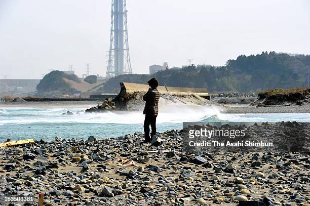 Woman prays at a beach where she lost her aunt by the tsunami that was triggered by the Magnitude 9.0 earthquake tw years ago on March 10, 2013 in...