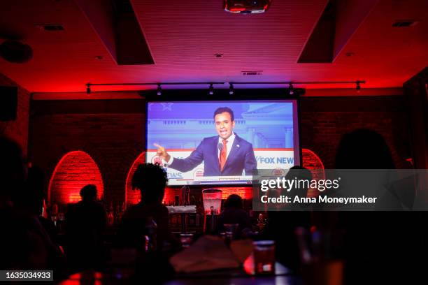 Republican presidential candidate Vivek Ramaswamy is displayed on television screens at a watch party for the first 2024 Republican presidential...