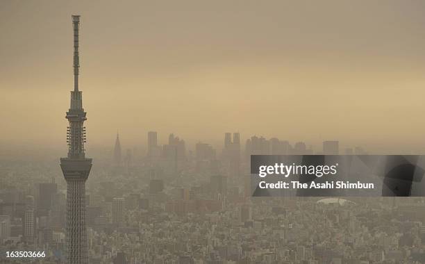 In this aerial image, haze covered Tokyo is seen on March 10, 2013 in Tokyo, Japan. Strong Northern wild by the cold front blow up dust and cover...