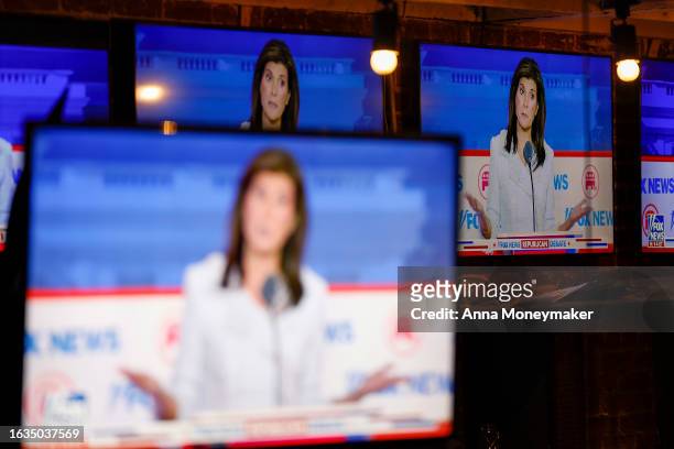 Republican presidential candidate, former U.N. Ambassador Nikki Haley is displayed on television screens at a watch party for the first 2024...