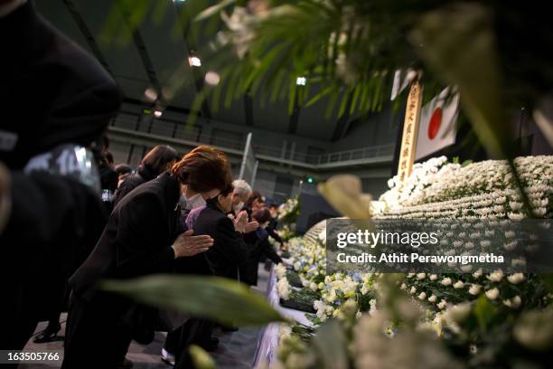 Japanese people pay their respect during a memorial ceremony to commemorate the victims of the 2011 earthquake and subsequent tsunami on March 11,...