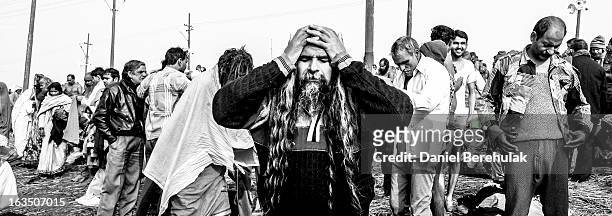 Hindu devotees dress themselves after having bathed on the banks of Sangam on January 13, 2013 in Allahabad, India. The Maha Kumbh Mela, believed to...