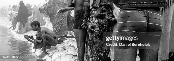 Hindu devotees bathe on the banks of Sangam as people gather ahead of the Maha Kumbh Mela on January 13, 2013 in Allahabad, India. The Maha Kumbh...