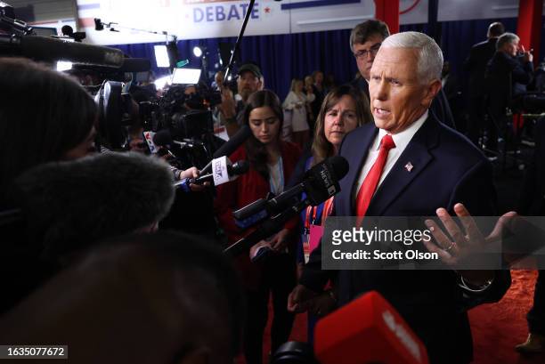 Republican presidential candidate, former U.S. Vice President Mike Pence talks to members of the media in the spin room following the first debate of...