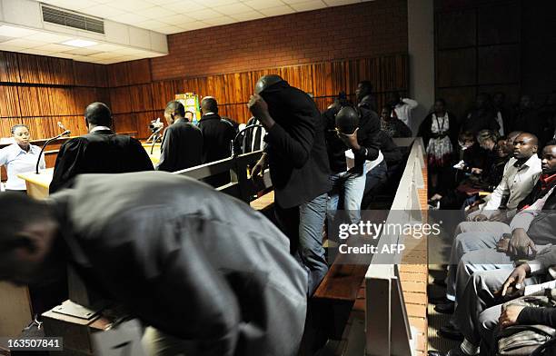 Policemen accused of the death of Mozambican taxi driver Mido Macia appear in the Benoni Magistrate's Court on March 11, 2013. Bystanders on February...