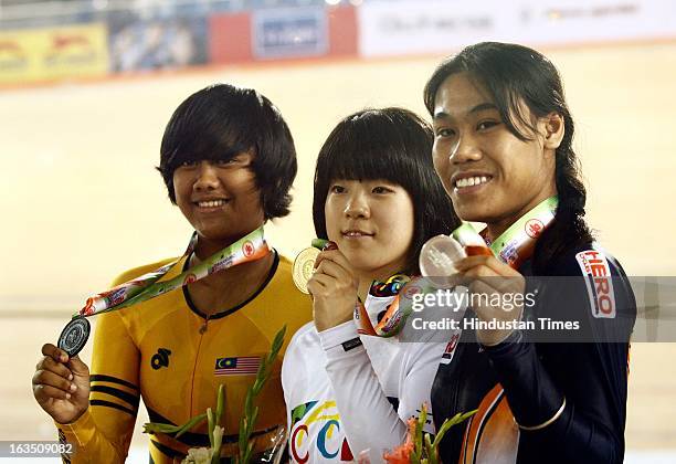 Gold medal winner Korea's Jang Yeonhee flanked by silver medal winner Deborah of India and bronze medal winner Farihah Shah Mohd Adnan of Malyasia...