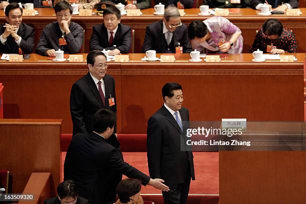 Newly-appointed Chairman of the Chinese People's Political Consultative Conference Yu Zhengsheng and outgoing Chairman Jia Qinglin attends the during...