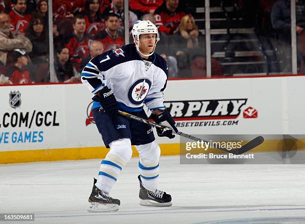 Derek Meech of the Winnipeg Jets skates against the New Jersey Devils at the Prudential Center on March 10, 2013 in Newark, New Jersey. The Devils...