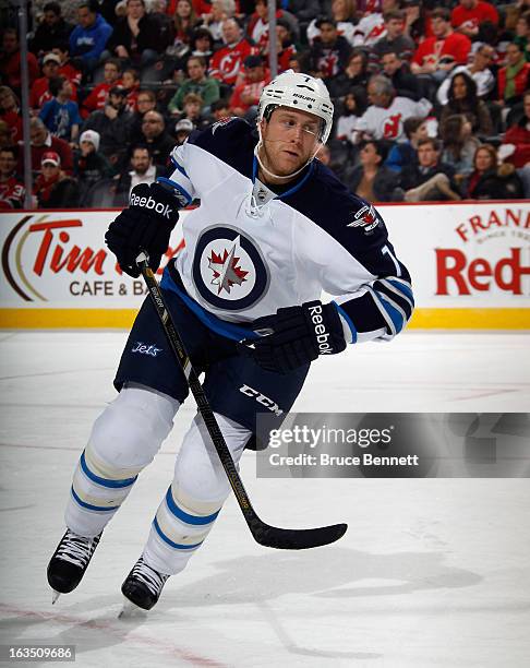 Derek Meech of the Winnipeg Jets skates against the New Jersey Devils at the Prudential Center on March 10, 2013 in Newark, New Jersey. The Devils...