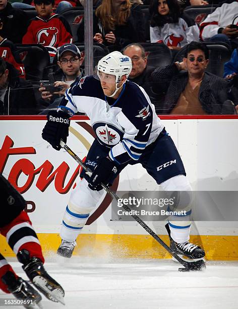 Derek Meech of the Winnipeg Jets skates against the New Jersey Devils at the Prudential Center on March 10, 2013 in Newark, New Jersey. The Devils...