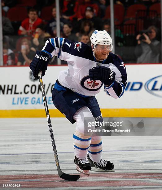 Derek Meech of the Winnipeg Jets skates against the New Jersey Devils at the Prudential Center on March 10, 2013 in Newark, New Jersey. The Devils...