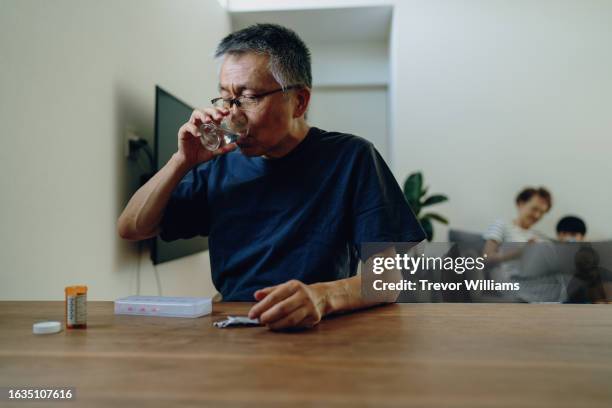 senior man taking various medications - antibiotic stock pictures, royalty-free photos & images