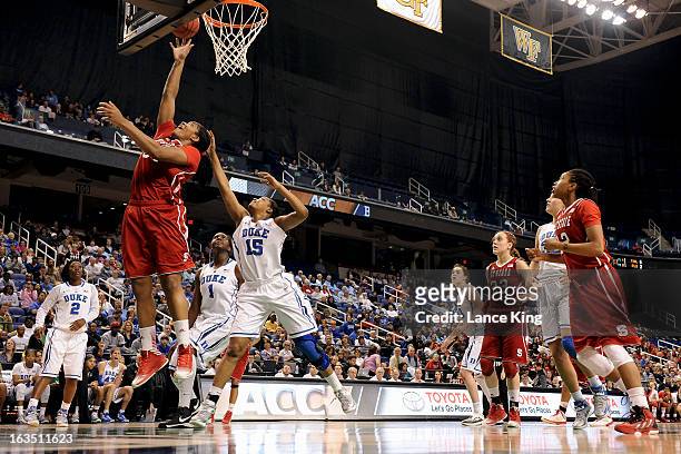Markeisha Gatling of the North Carolina State Wolfpack puts up a shot against Richa Jackson of the Duke Blue Devils during the quarterfinals of the...