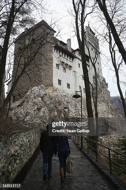 Visitors walk up to Bran Castle, famous as "Dracula's Castle," on March 10, 2013 in Bran, Romania. Bran Castle's reputation as the supposed home to...