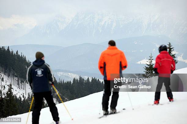 Skiers prepare to head down a slope at the Poiana Brasov ski resort in the Bucegi mountains on March 9, 2013 at Poiana Brasov, Romania. Romania is...