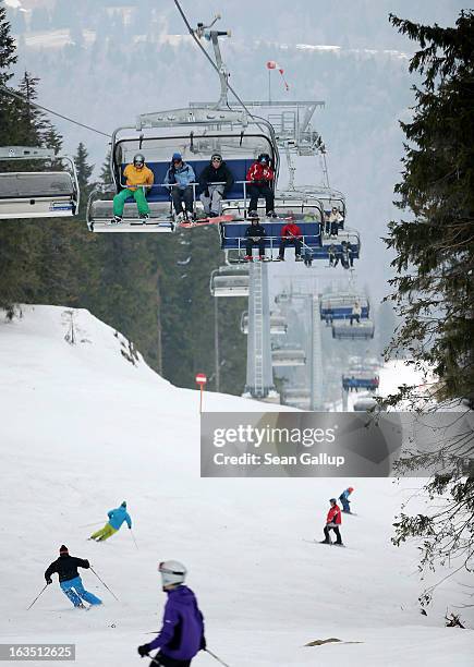 Skiers and snowboarders take in late winter pistes in the Bucegi mountains on March 9, 2013 at Poiana Brasov, Romania. Romania is eager to promote...