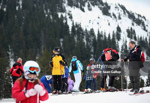 Skiers and snowboarders take in late winter pistes in the Bucegi mountains on March 9, 2013 at Poiana Brasov, Romania. Romania is eager to promote...