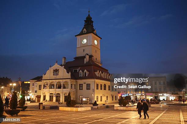 People walk past the former Council House, built in 1420, in Sfatului square on March 9, 2013 in Brasov, Romania. Brasov, in German called Kronstadt,...