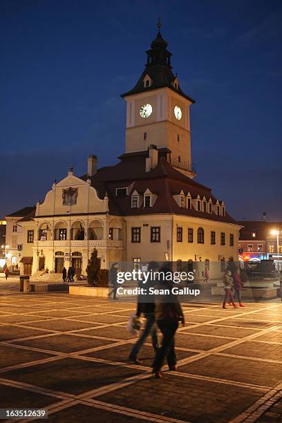 People walk past the former Council House, built in 1420, in Sfatului square on March 9, 2013 in Brasov, Romania. Brasov, in German called Kronstadt,...