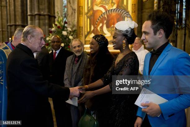 Britain's Prince Philip, the Duke of Edinburgh meets members of the British band Noisettes, singer Shingai Shoniwa, and guitarist Dan Smith the...