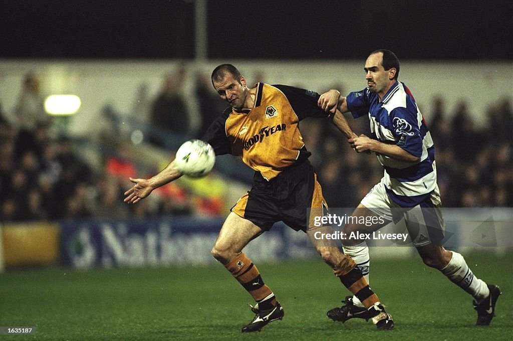 Steve Bull of Wolves fends off a tackle from a QPR player