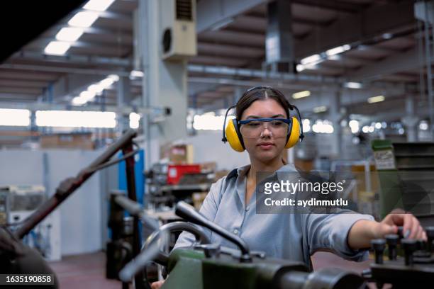 young lathe worker woman working with milling machine in factory - milling stock pictures, royalty-free photos & images