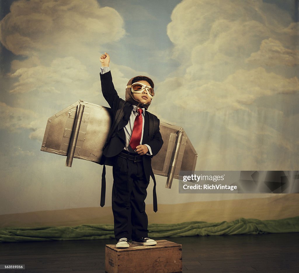 Young Boy dressed as Businessman Wearing Jet Pack