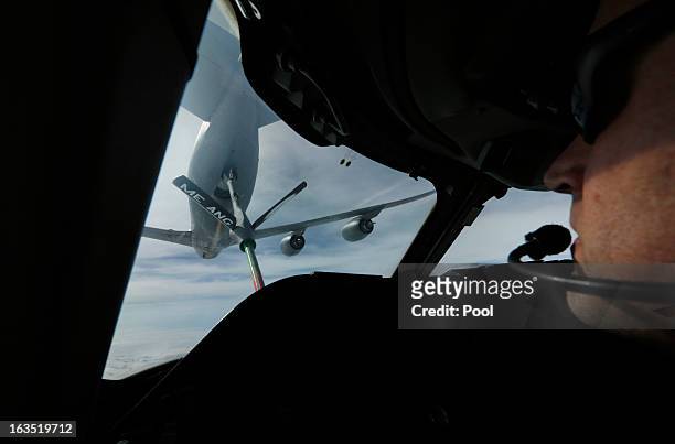 Tanker aircraft is pictured during a mid-air refueling of U.S. Secretary of Defense Chuck Hagel's E-4B, a militarized version of a Boeing 747, as he...