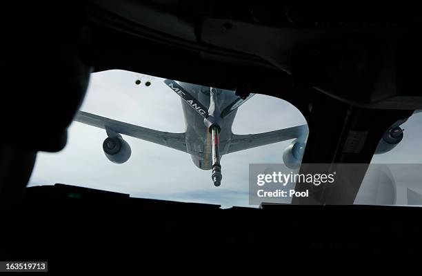 Tanker aircraft is pictured during a mid-air refueling of U.S. Secretary of Defense Chuck Hagel's E-4B, a militarized version of a Boeing 747, as he...