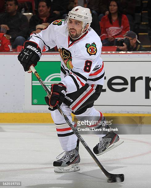 Nick Leddy of the Chicago Blackhawks passes the puck during an NHL game against the Detroit Red Wings at Joe Louis Arena on March 3, 2013 in Detroit,...