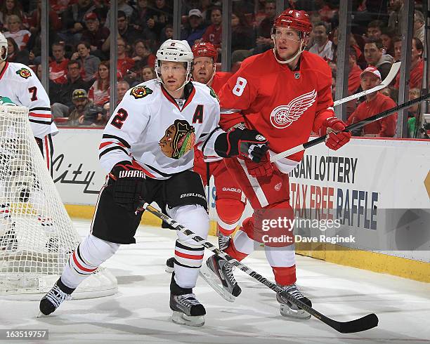 Duncan Keith of the Chicago Blackhawks skates next to Justin Abdelkder of the Detroit Red Wings at Joe Louis Arena on March 3, 2013 in Detroit,...