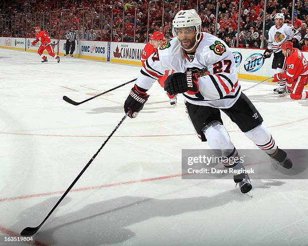 Johnny Oduya of the Chicago Blackhawks follows the play during an NHL game against the Detroit Red Wings at Joe Louis Arena on March 3, 2013 in...