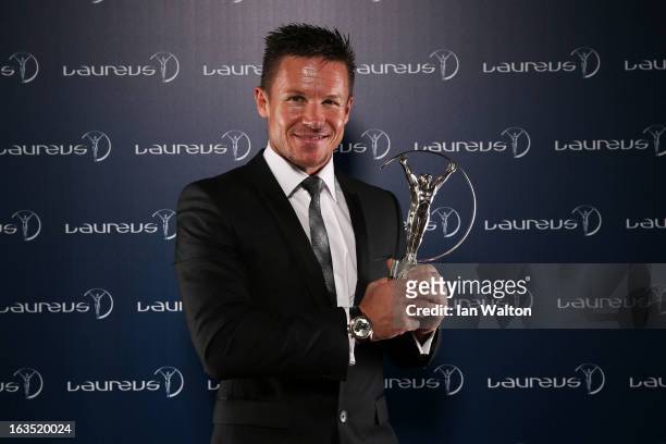 Sky Diver Felix Baumgartner poses with the award for Laureus World Action Sportsperson of the Year in the winners studio during the 2013 Laureus...