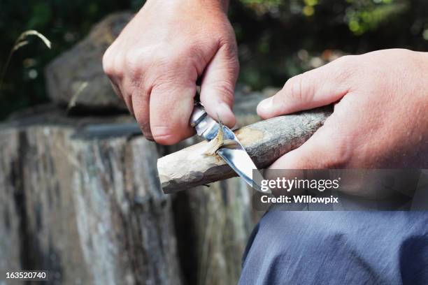 man carving wooden stick - wooden stick stock pictures, royalty-free photos & images