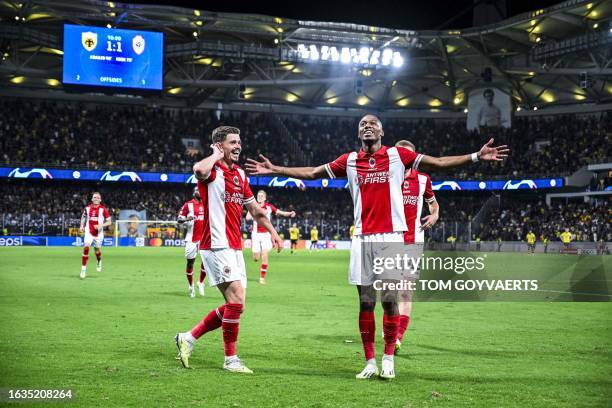 Antwerp's Arbnor Muja, Antwerp's Michel Ange Balikwisha and celebrate after scoring during a soccer game between Greek AEK Athens FC and Belgian...