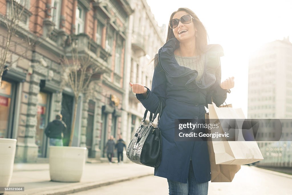 Smiling girl with shopping bags