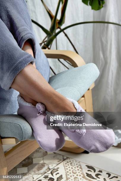 crop woman sitting on chair wearing home socks - adjust socks bildbanksfoton och bilder