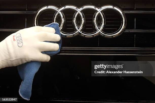 An Audi employee polishes the hood of an Audi A3 automobile, produced by Volkswagen AG's Audi brand, as it moves along the production line at the...