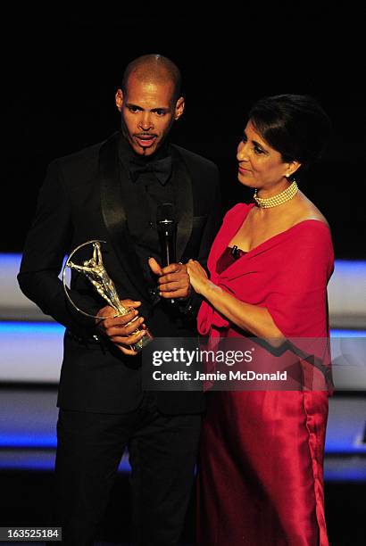 Athlete Felix Sanchez accepts his award for "Laureus World Comebcak of the Year" from Laureus Academy Member Nawal El Moutawakel during the awards...