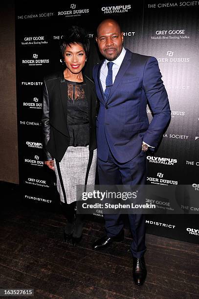 Actress Angela Bassett and director Antoine Fuqua attend The Cinema Society with Roger Dubuis and Grey Goose screening of FilmDistrict's "Olympus Has...