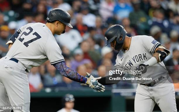 Gleyber Torres of the New York Yankees celebrates with Giancarlo Stanton after hitting a solo home run against the Detroit Tigers during the fourth...