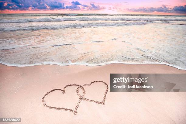 two hearts at the beach - sand heart stock pictures, royalty-free photos & images