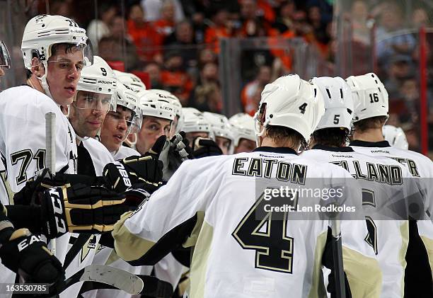 Evgeni Malkin, Pascal Dupuis and Sidney Crosby of the Pittsburgh Penguins celebrate a goal with their teammates against the Philadelphia Flyers on...