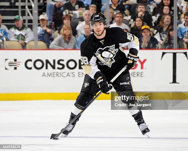 Kris Letang of the Pittsburgh Penguins moves the puck against the New York Islanders on March 10, 2013 at Consol Energy Center in Pittsburgh,...